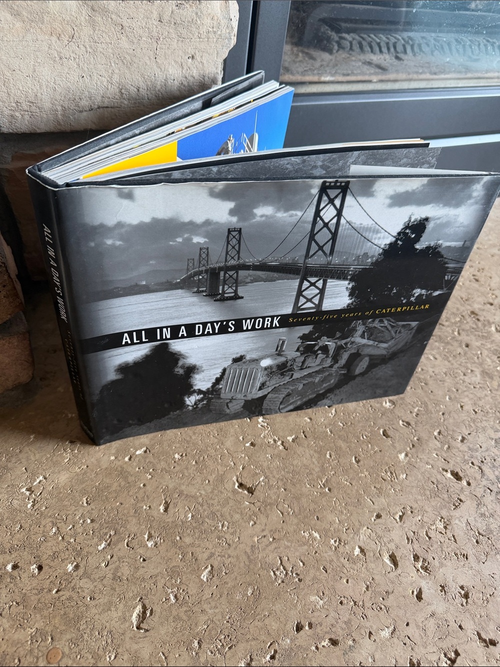 Caterpillar Black and Gray Hardcover Coffee Table Book All in. Day’s Work
